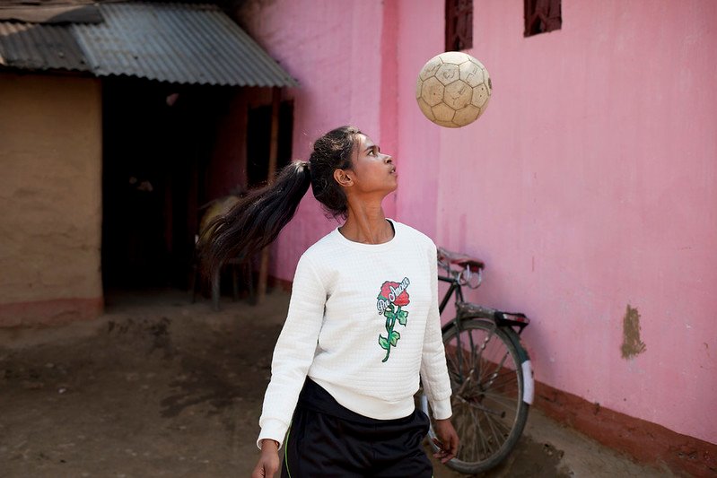 Binita, 15, a member of Smriti Adolescent Girls Group on the Rupai Tea Estate, Tinsukia, Assam, India. She wants to be a footballer. Photographed with her father: Bhokkhor Dhan Tanti, mother: Bhaben Tanti and her nephew Dipak Tanti, 3.5 years and neice Mandina Tanti, 3 years.